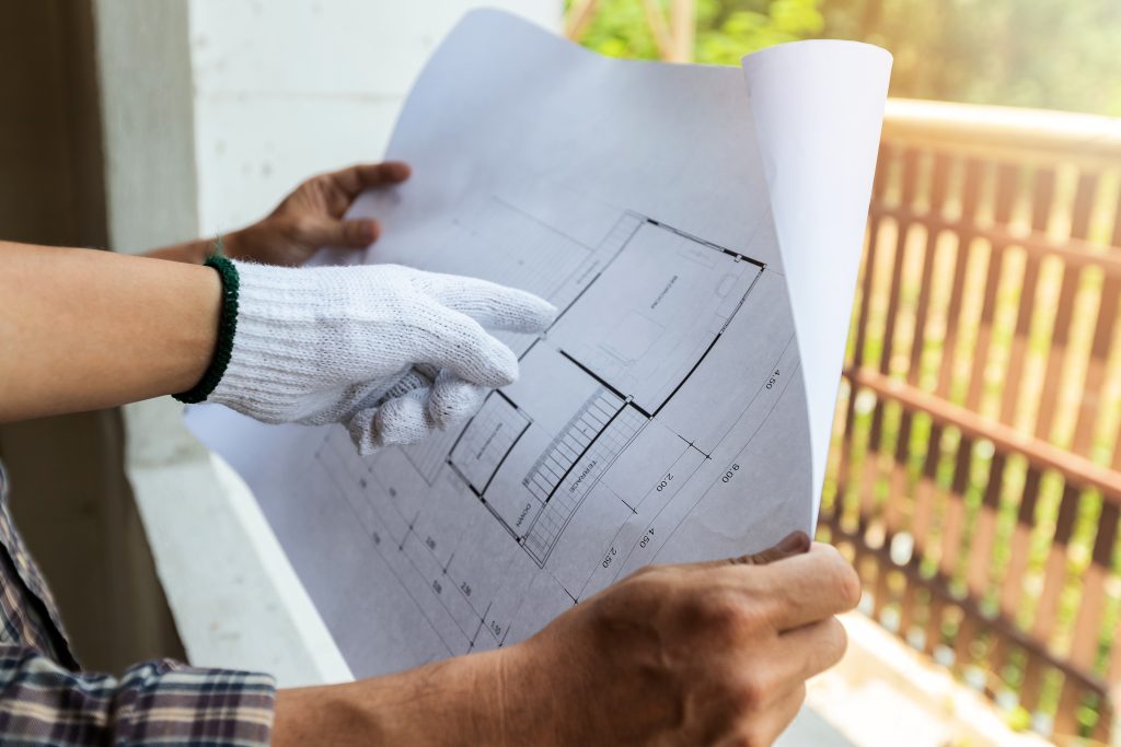 Architect discuss with foreman about project in construction site